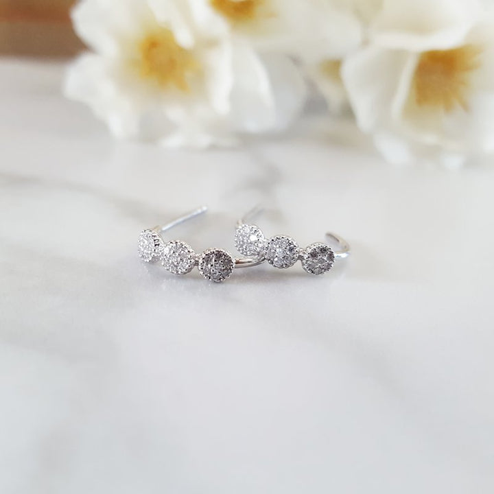 Gems One Diamond Triple Halo Cluster Earrings In 10K White Gold (1/8 Ctw) ER27897-1WD